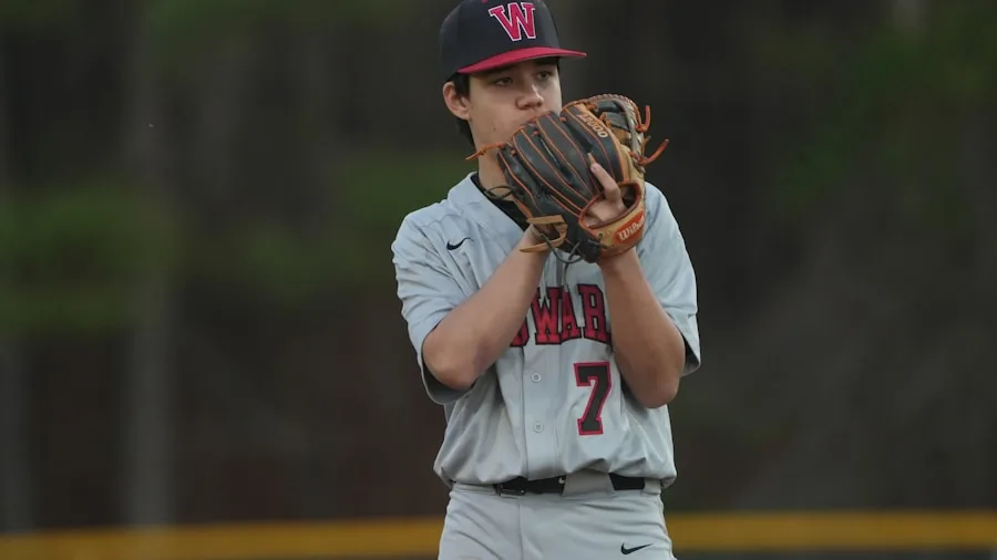 Youth baseball player demonstrating proper glove fit and positioning while playing catch outdoors